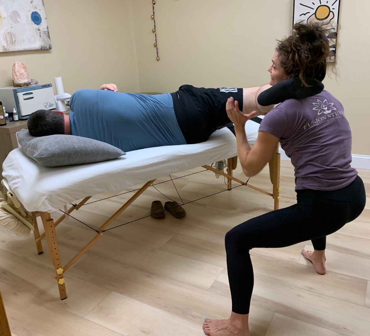 Elizabeth Elliott with Fusion Stretch & Wellness helps Keith Kaiser get more flexible